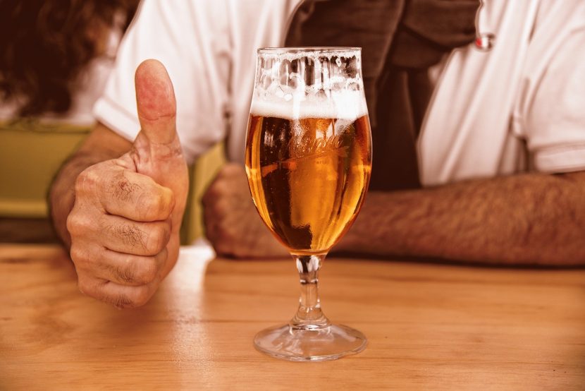 Glass of beer with hand
