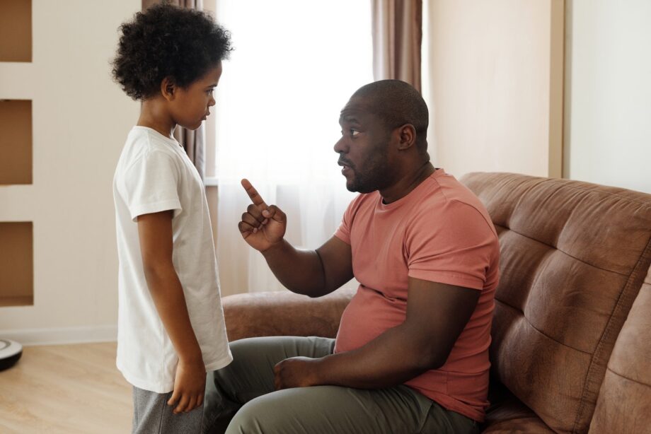 Father talking to child and wagging finger
