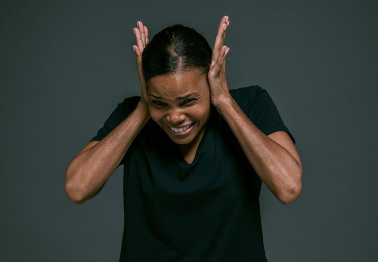 4 A Solution for the Audio Overload - woman holding hands on ears