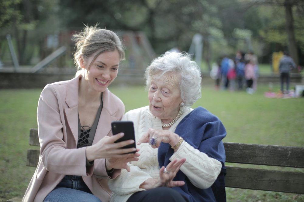 Older woman and younger woman with phone