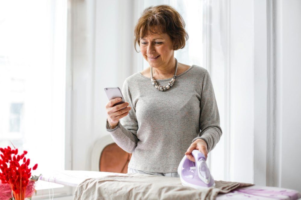 Woman with iron and phone